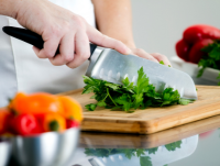 Image of a person cutting vegetables